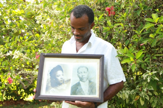 Reynaldo Matthews holds the portrait of his grandparents